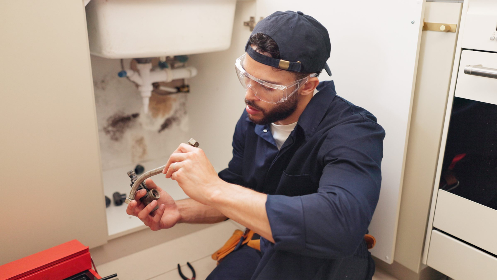 Plumber checking pipes instead of doing SEO for his business