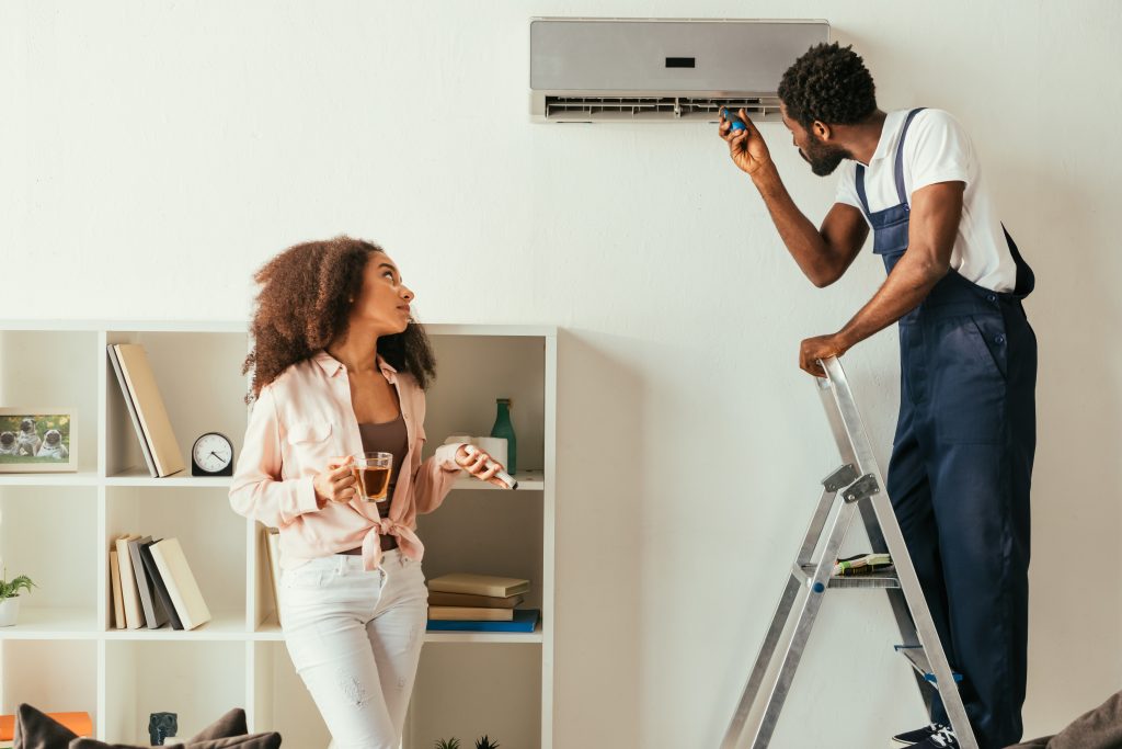 african american repairman fixing air conditioner 2024 11 17 14 34 15 utc