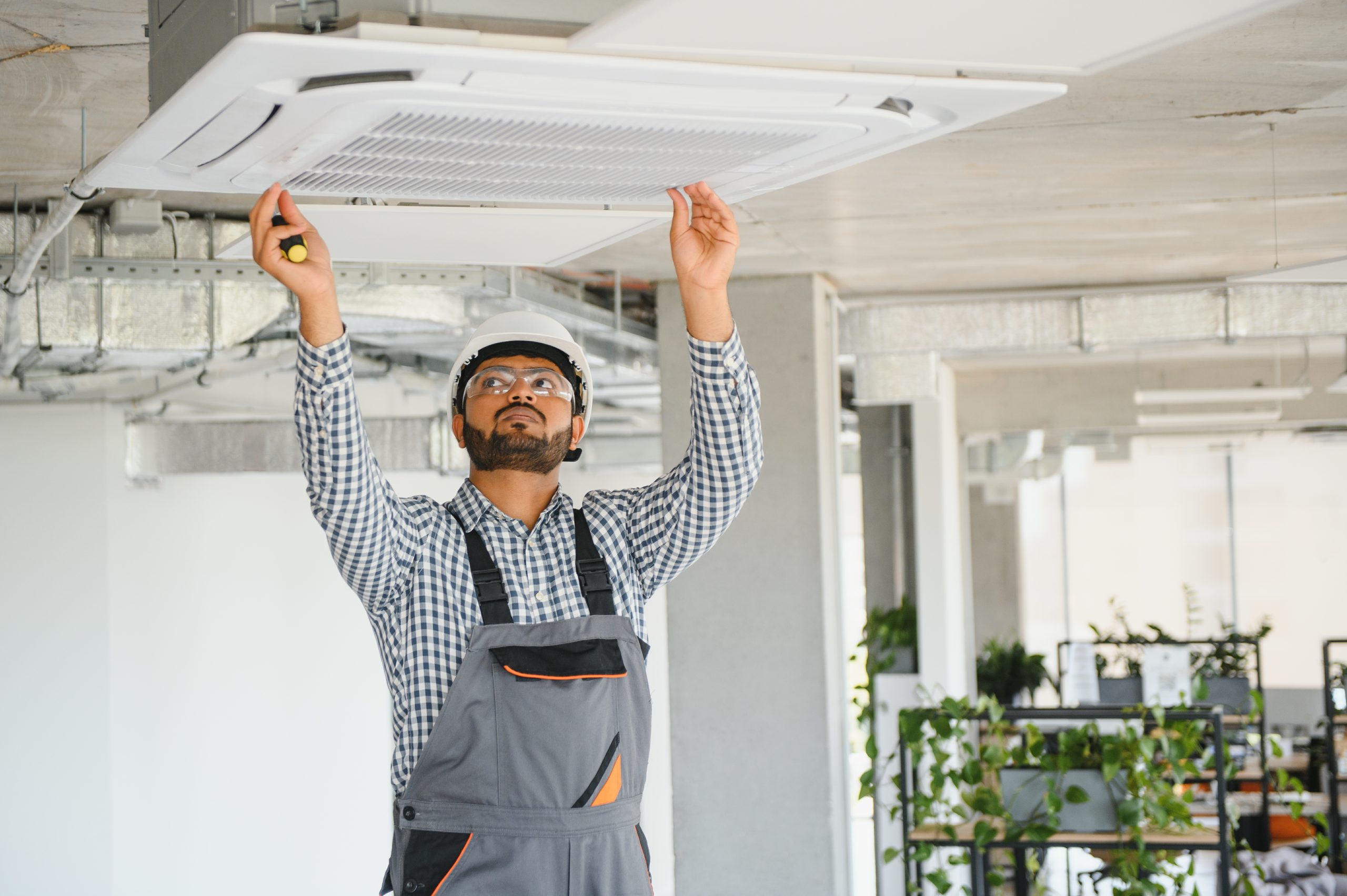 indian male worker inspecting the air conditioner 2025 03 15 05 17 12 utc scaled