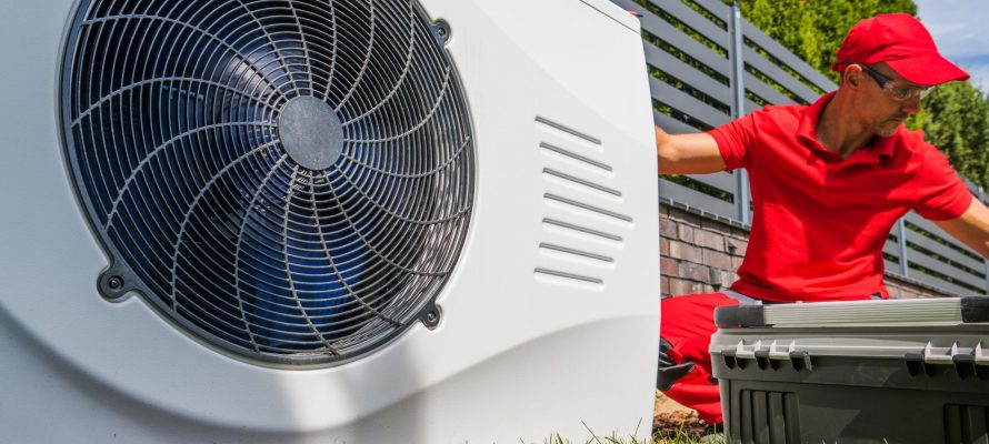 Professional HVAC Worker Installing Swimming Pool Heat Pump Professional HVAC Worker in His 40s Installing Swimming Pool Heat Pump Outdoor Water Heating Device. Energy Saving Technologies.